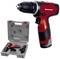 A red cordless drill positioned next to its grey carry case with charger and accessories on a white background.