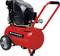 Red portable air compressor with black motor housing, handle, pressure gauges, and large wheels on a white background.