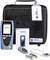 Network tester set with NaviTEK NT device, manual, remote control, batteries and cables in front of black carrying case.