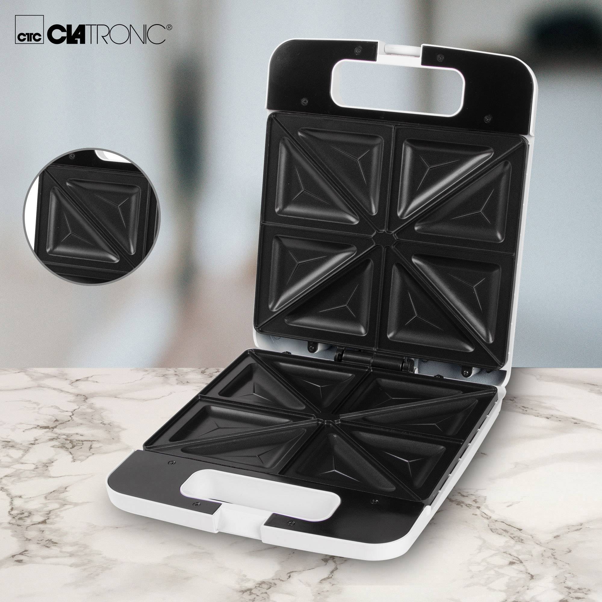 An open sandwich toaster on a marble worktop. A closed sandwich toaster shown in detail in the top left corner.