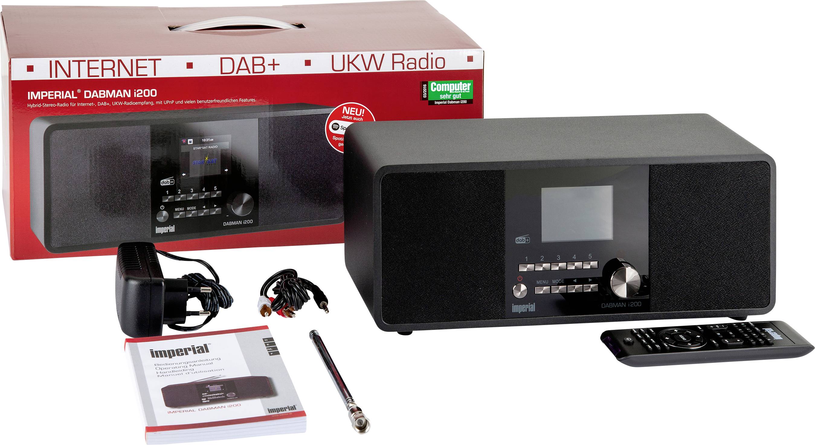 A black radio with a display and controls, alongside a remote control, cables, an aerial, and the instruction manual. Packaging in the background.