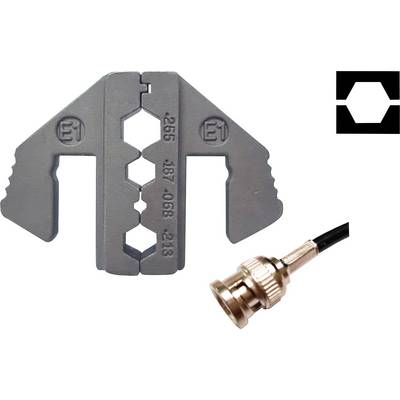 Crimping tool with hexagonal openings next to a coaxial connector.