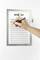 A pen marks an activity list titled 'ACTIFIT CARDIO'. The list has columns for names and dates, pinned to a wall.