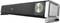 Black soundbar with silver volume control, green illuminated display, two connections, and Trust logo on the left.