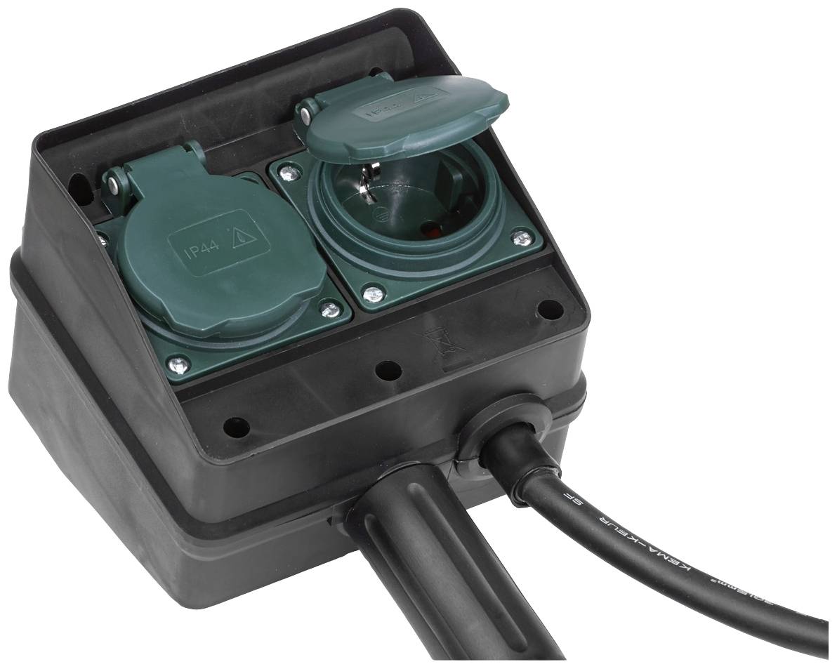 A black, weatherproof extension socket with two green sockets, one of which has a closed cover. A cable is connected.