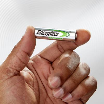 A hand is holding a rechargeable AAA battery from the brand 'Energizer'. The battery is marked with a positive plus sign.