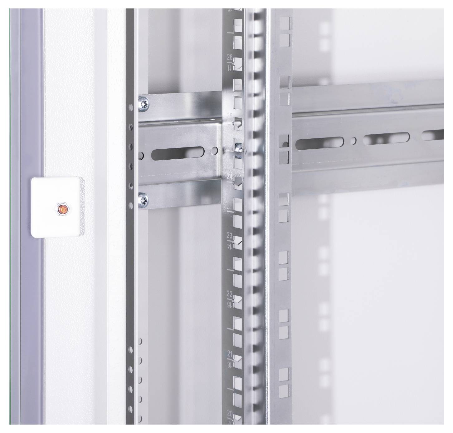 Metal frame of an electrical control cabinet with mounted mounting brackets and a small white switch on the left side.