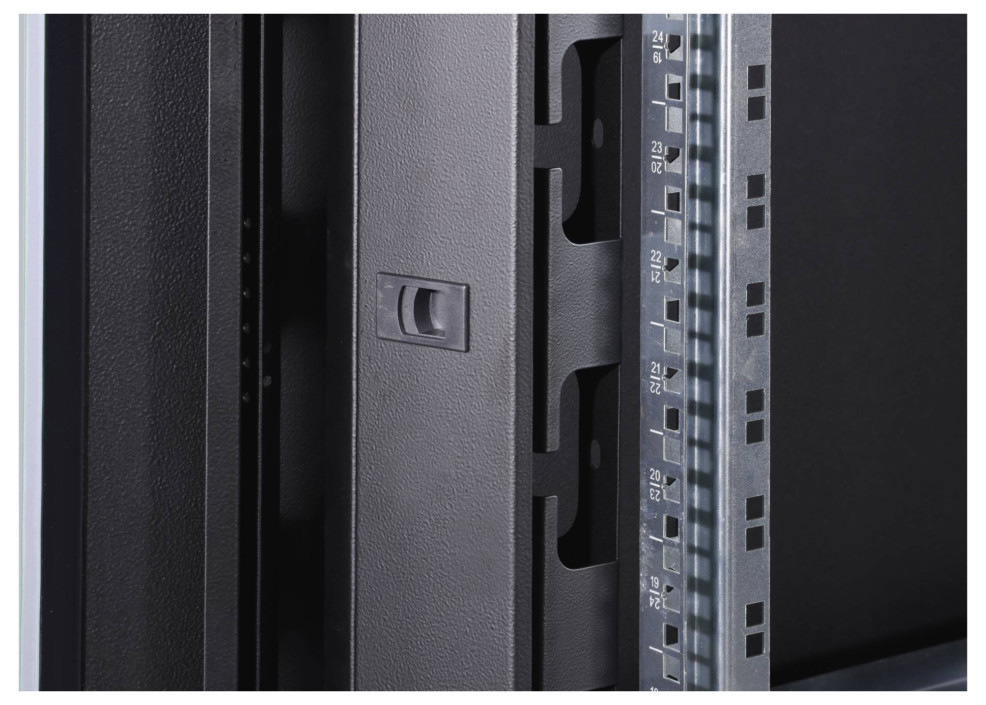 'A black metal hinge on a greyscale rack with a numbered scale on the right side.'