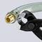 A close-up of a transparent tube with a brass fitting being held by an adjustable spanner.
