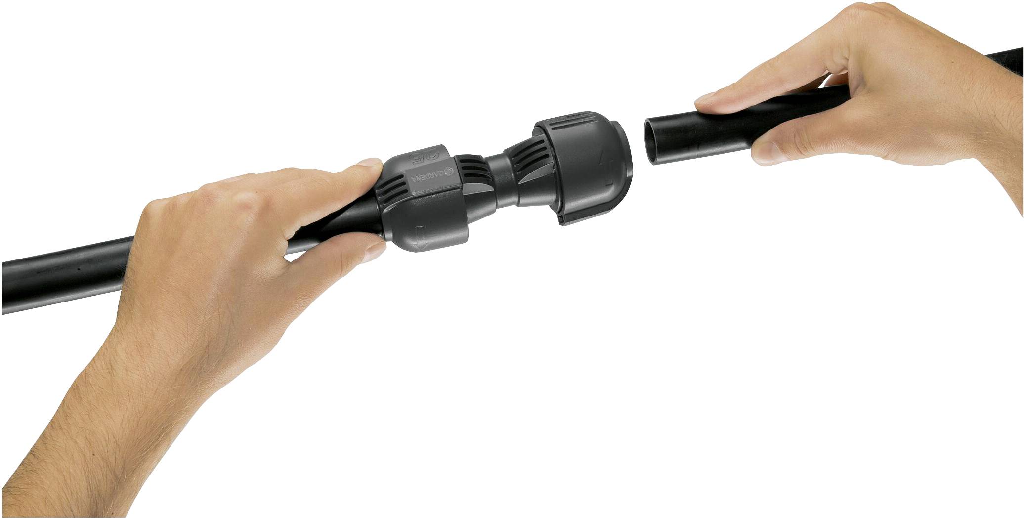 Two hands are connecting two black pipes with a coupling piece.