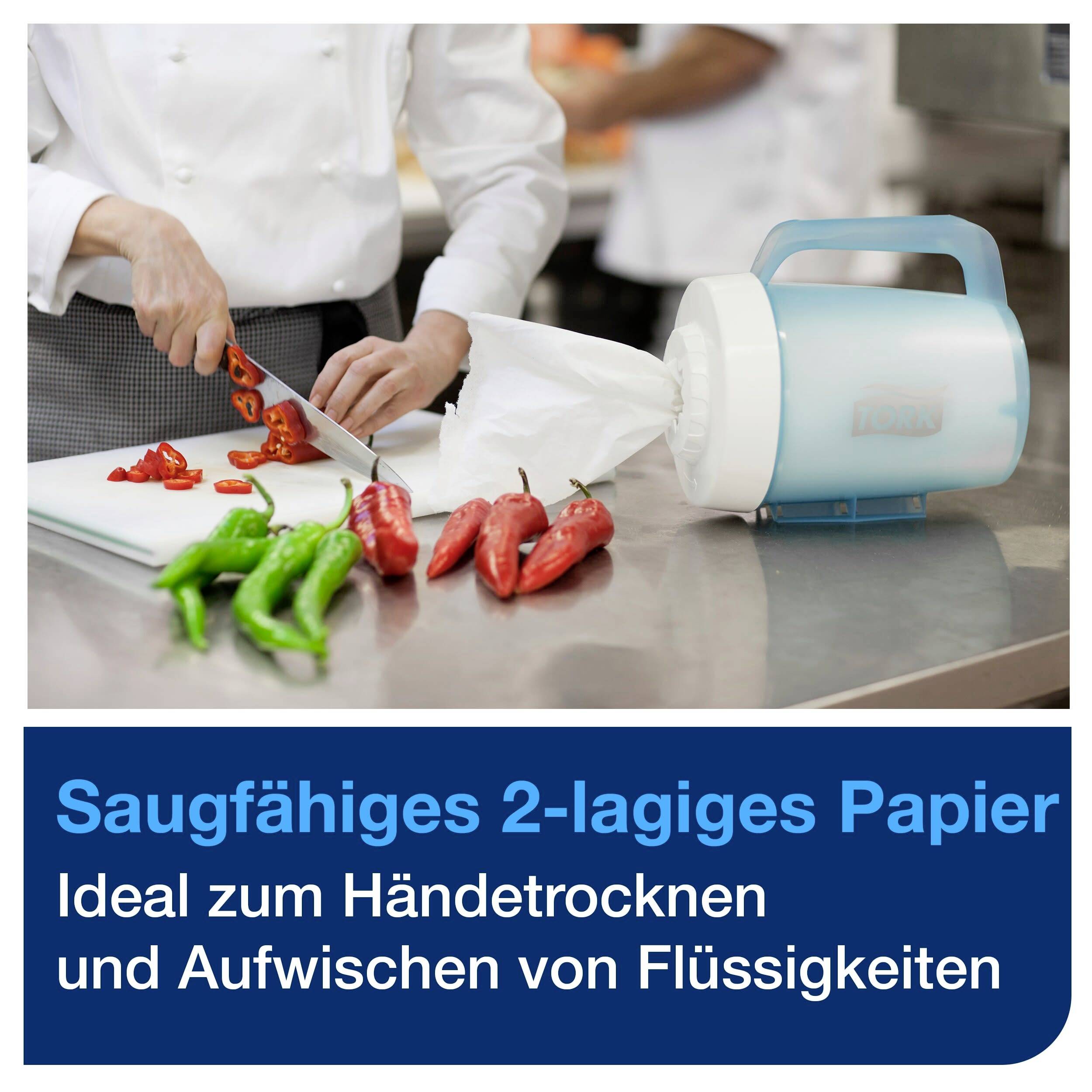 A person is chopping red peppers. On a table, there is kitchen roll, labelled 'Absorbent 2-ply paper'.