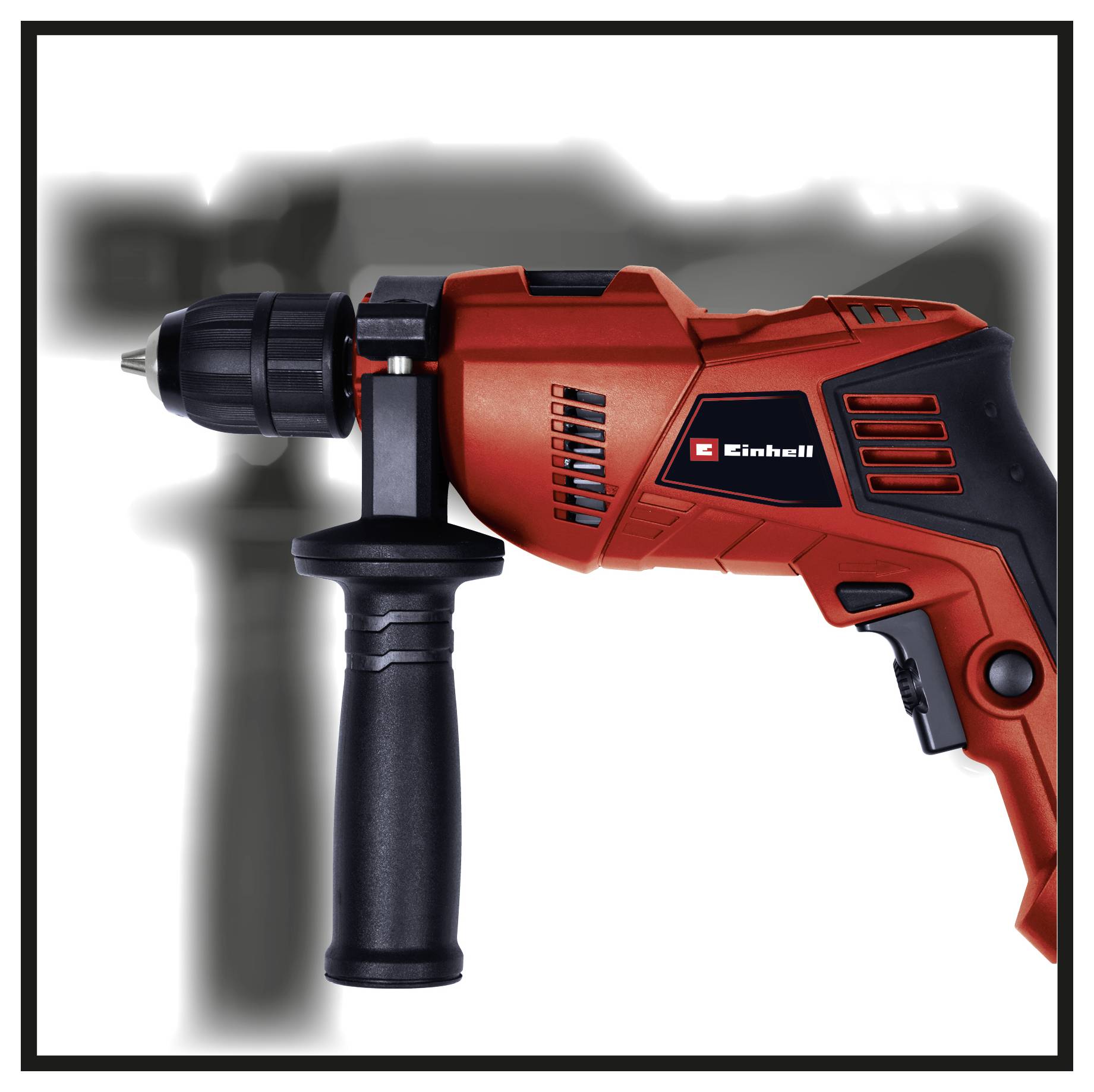 A red hammer drill with a side handle, marked with 'Einhell', lies in front of a blurry background with tool silhouettes.