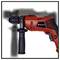 A red hammer drill with a side handle, marked with 'Einhell', lies in front of a blurry background with tool silhouettes.