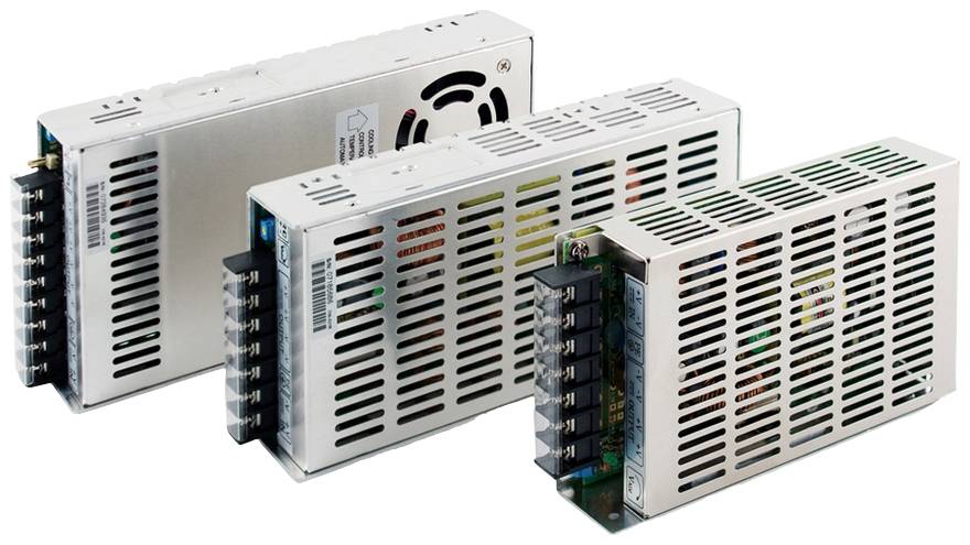 Three industrial power supplies side by side. They display ventilation slots and connection terminals. The devices are metallic and rectangular.