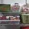 Plastic containers on shelves for holiday decorations: Containers labelled 'Baubles', 'Stockings' and 'Outdoor Lights'.