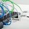 A cable holder with blue, white and green cables, labelled 'Phone', 'USB' and 'Laptop', organises multiple chargers.