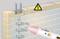 A voltage tester indicates electrical wires in a wall, symbolised by wave symbols and a warning sign for electrical voltage.