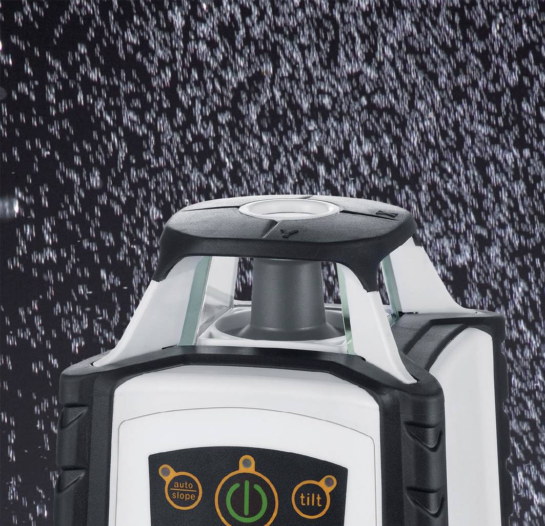 A rotating laser leveller, surrounded by water droplets, shows settings for 'auto slope' and 'tilt'.
