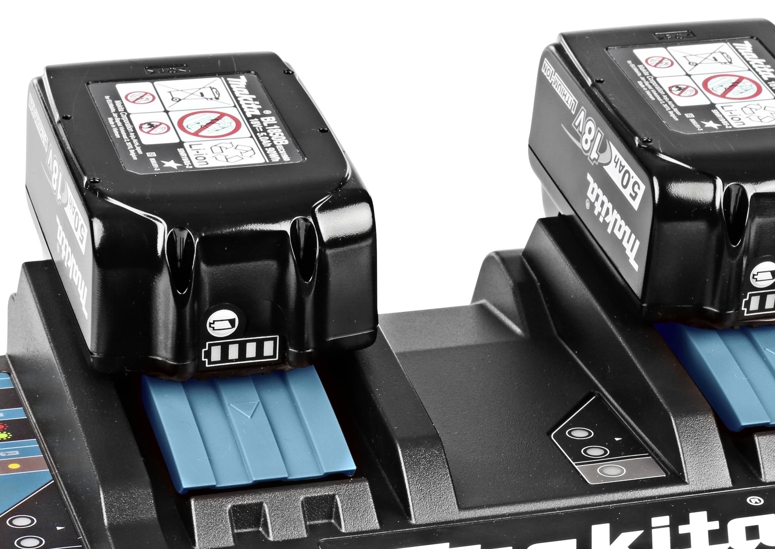 Two black batteries on a charging station, with blue inserts and stickers displaying safety instructions.