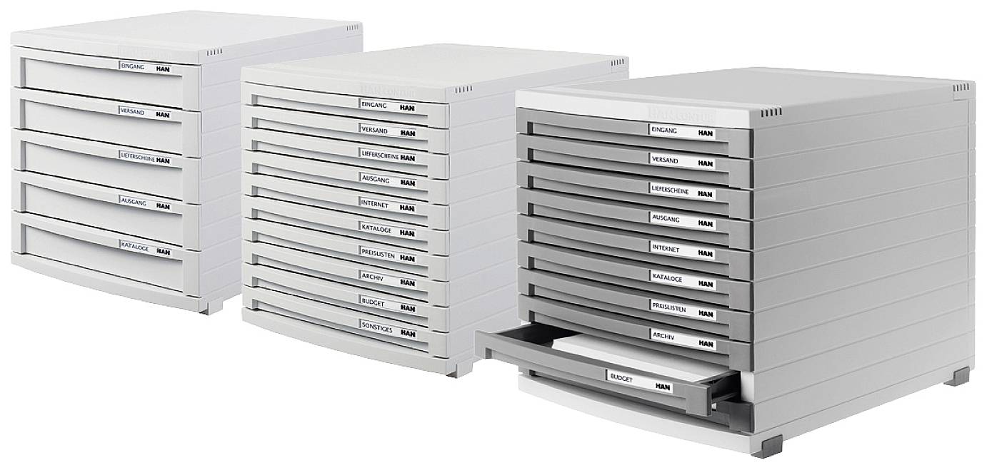 Three white paper feed cassettes with varying heights; the left one has three compartments, the middle one six, and the right one nine.