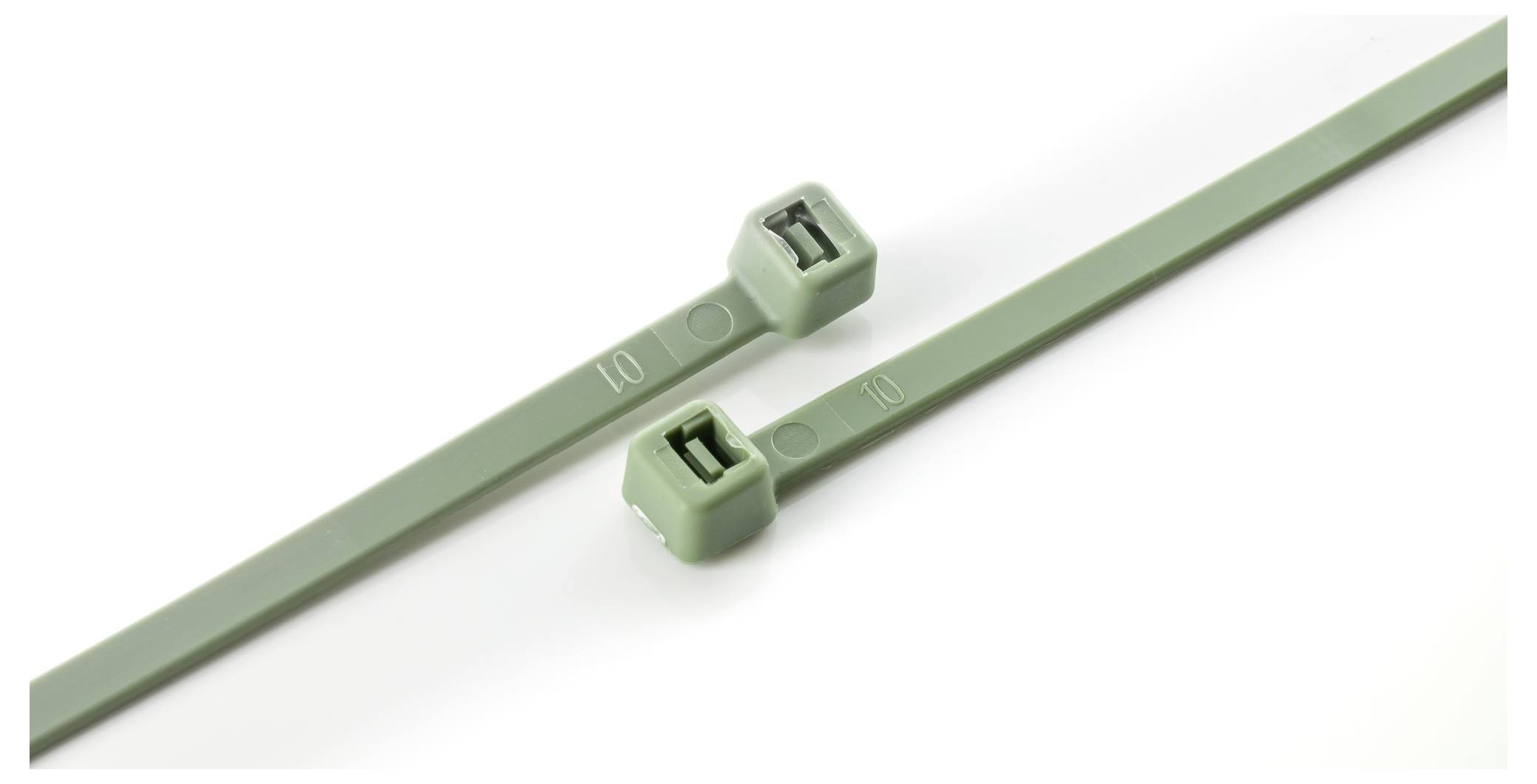 Two green cable ties are placed parallel on a white surface. The ties have rectangular locking mechanisms and ribbed edges.