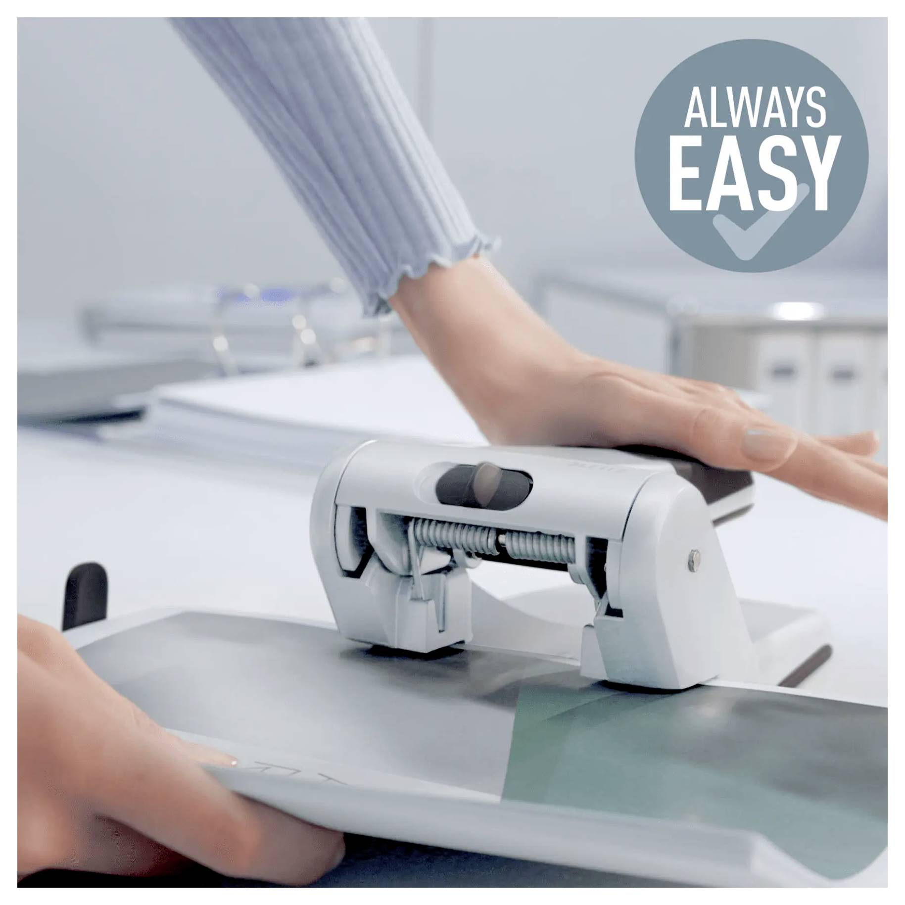 'A person using a white hole punch on paper, with text in the image reading 'Always Easy'.'