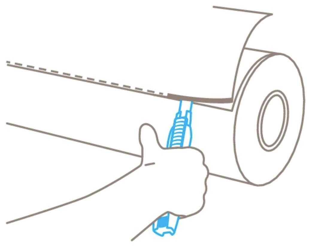 An arm cuts along a dotted line on a large roll of paper using a craft knife.