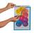 Hands placing a transparent cover over a colorful poster titled '10 Tipps für einen sicheren und gesunden Arbeitsplatz' with numbered tips.