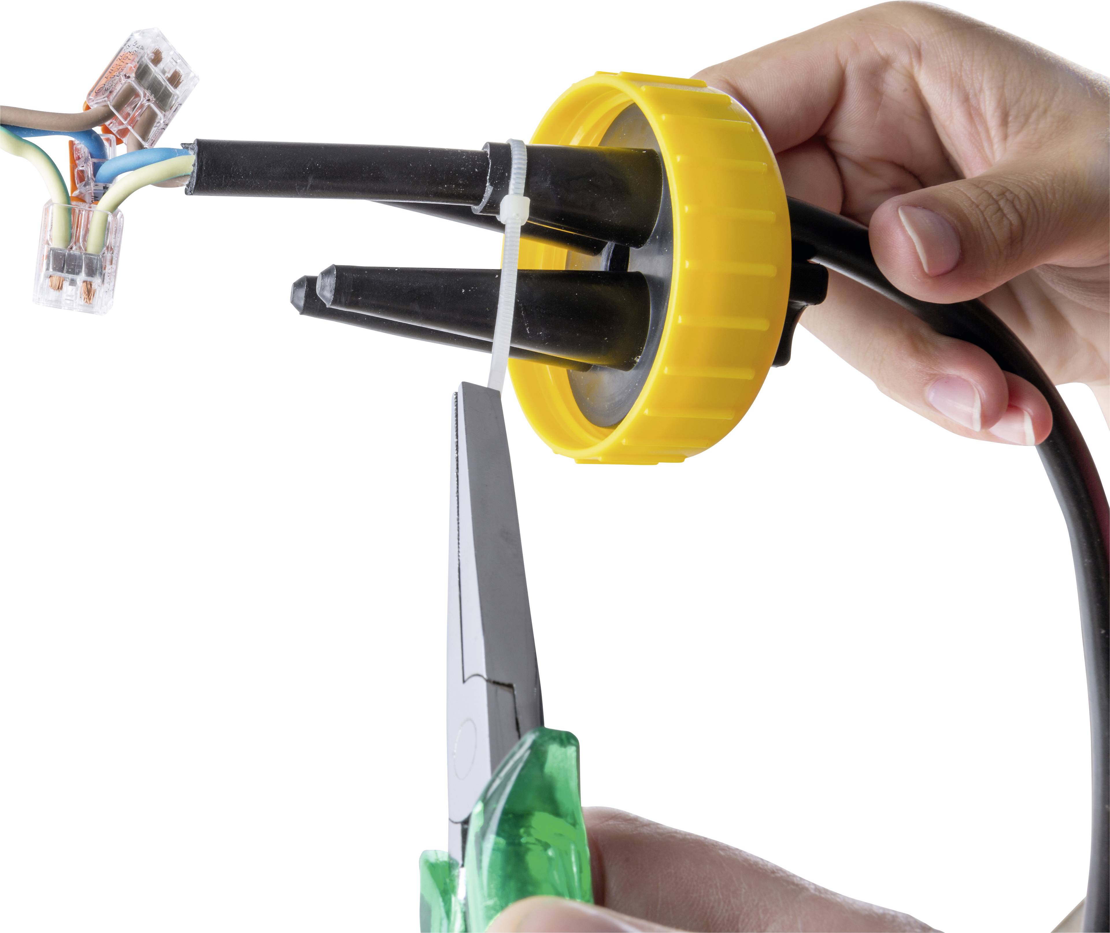 Two hands are cutting a cable tie with pliers, which secures two thick black cables to a yellow connector.