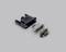 'A dismantled multi-pole plug with housing, terminal and metal pins on a grey background, to illustrate electrical components.'