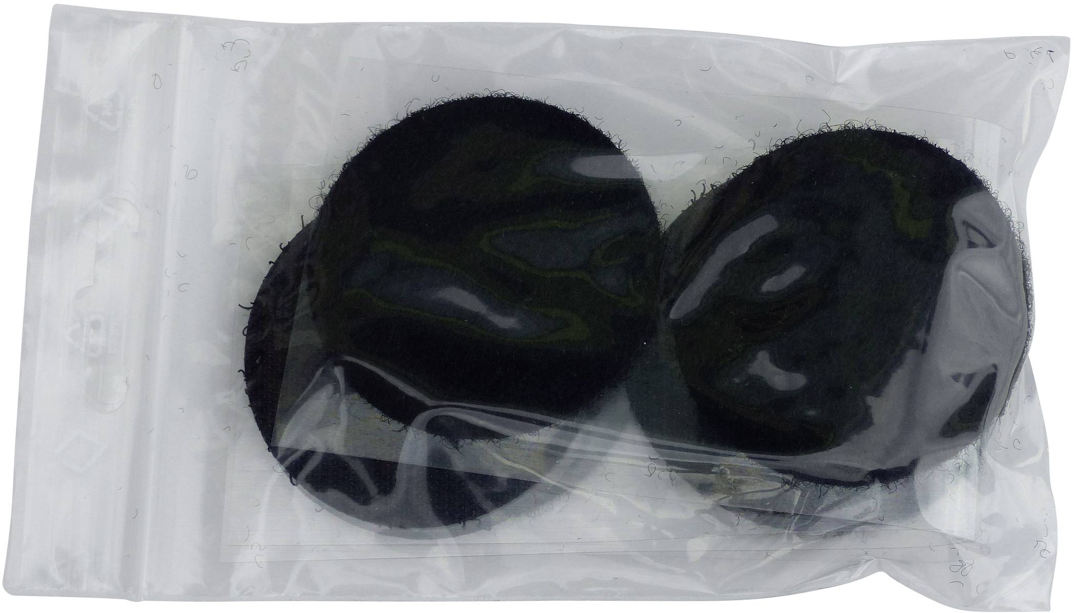 Two black felt pads in a sealed, transparent plastic bag.