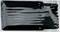 A transparent plastic packaging containing several black, elongated objects that look like cable ties or binding strips.