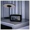 A digital alarm clock on a modern bedside table shows '2:00 AM'.