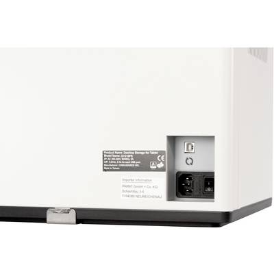 A white device with a label, mains socket, and USB port, used for tablet storage.