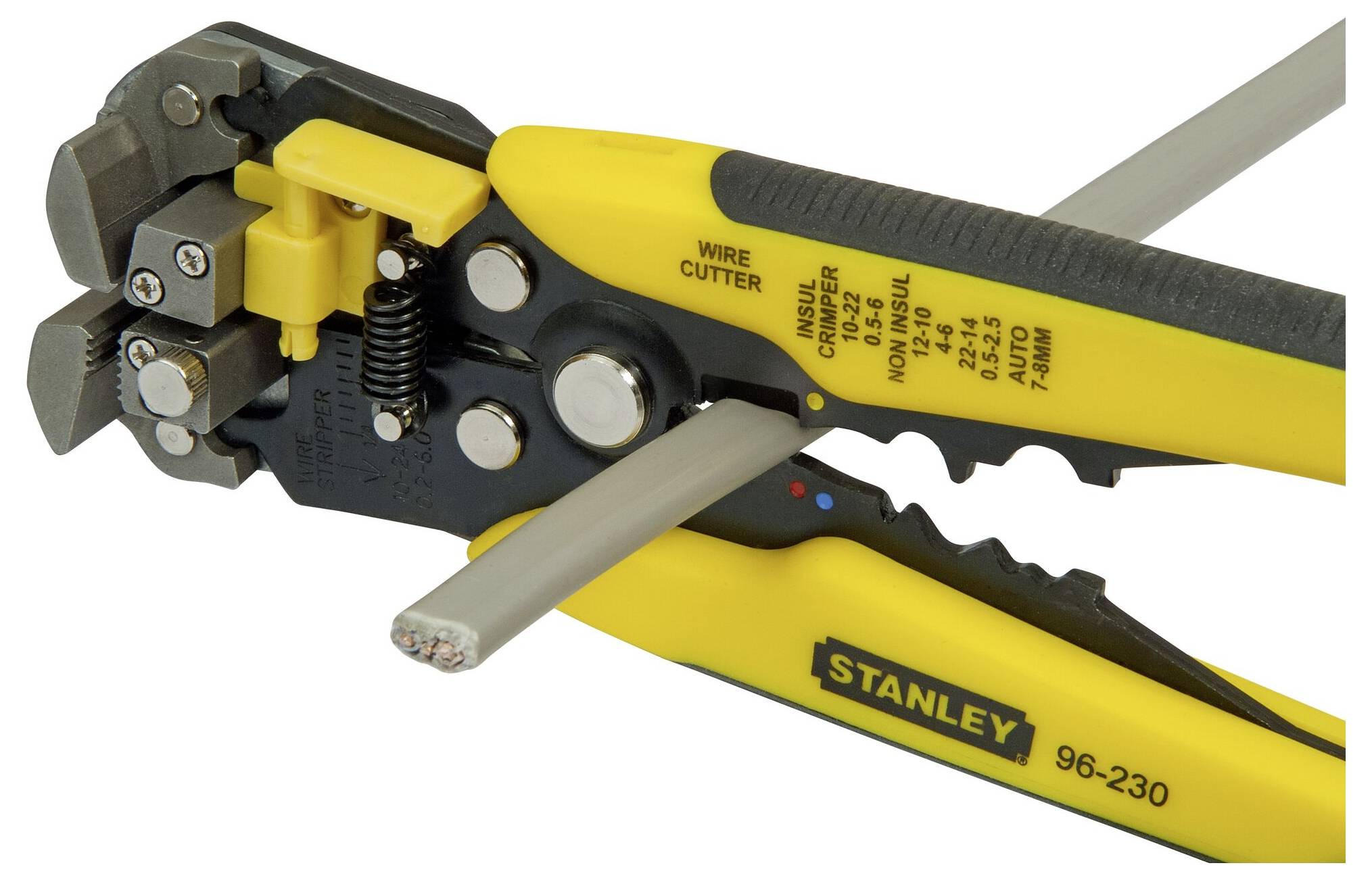 Wire strippers with a yellow handle cutting a grey cable.