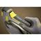 Human hands in work gloves hold and operate a nail gun used for construction or DIY projects.