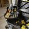 A tradesman opens a tool case filled with various tools, including a saw, tape measure, and drill.