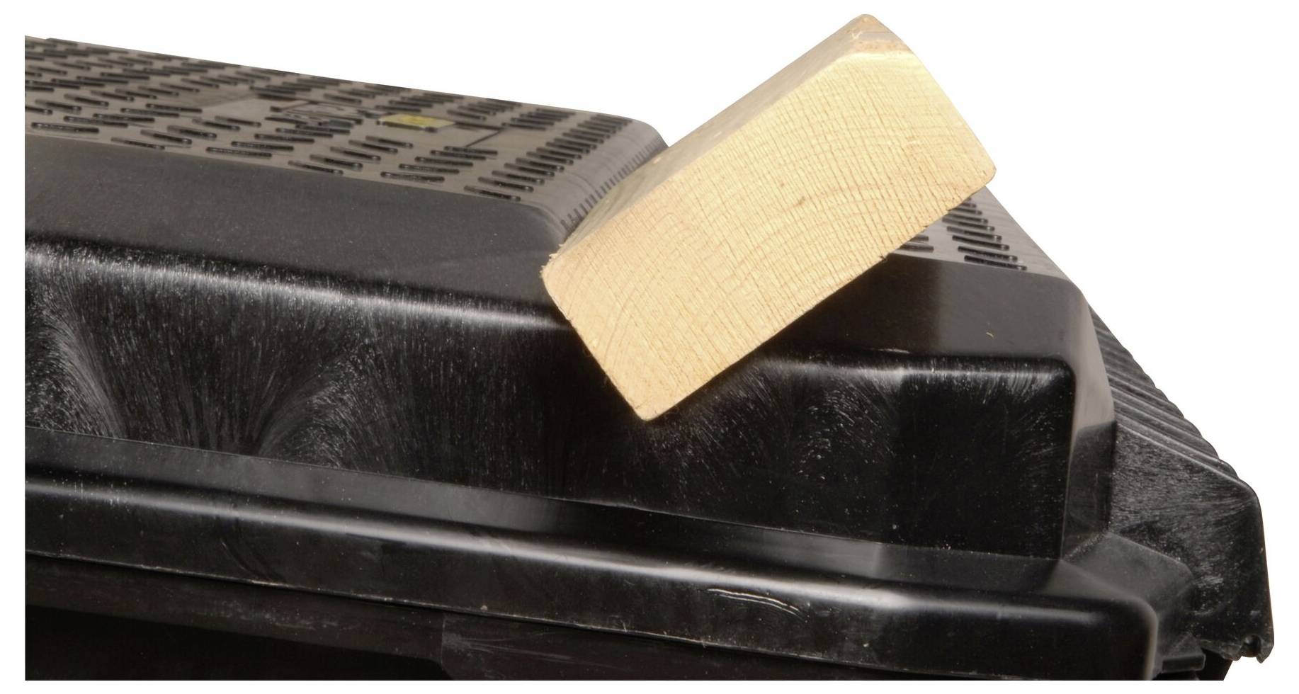 A black plastic part with a bevelled wooden cube on the top surface. The wood is light in colour and provides a contrast with the plastic.