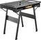 A folding, black work table with robust metal legs and a ribbed surface for secure grip during tasks.
