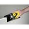 A hand is holding a yellow tool used to smooth the edge of a plasterboard.