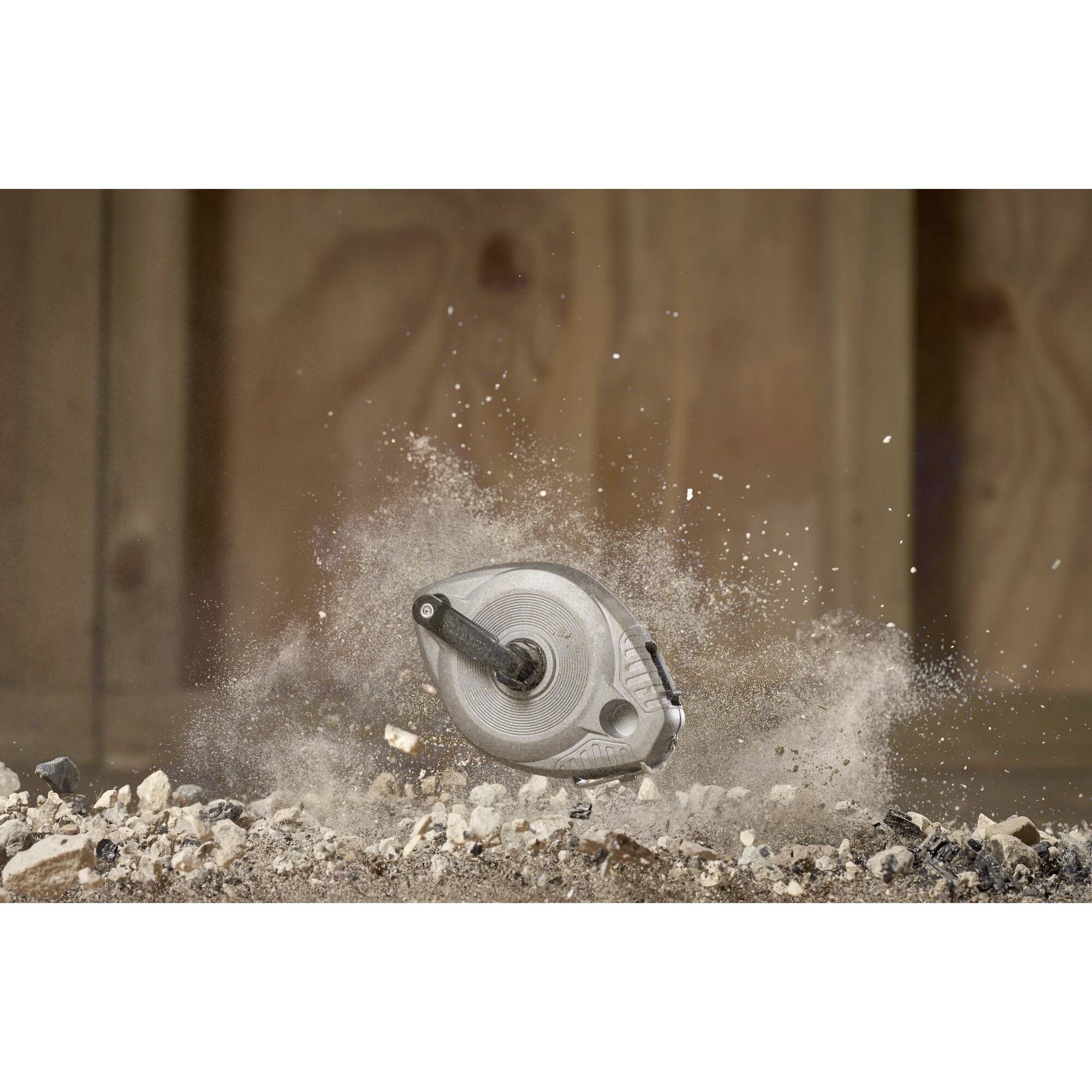 A circular saw cutting wood creates dust and wood shavings. The environment is a workshop with wood-panelled walls in the background.