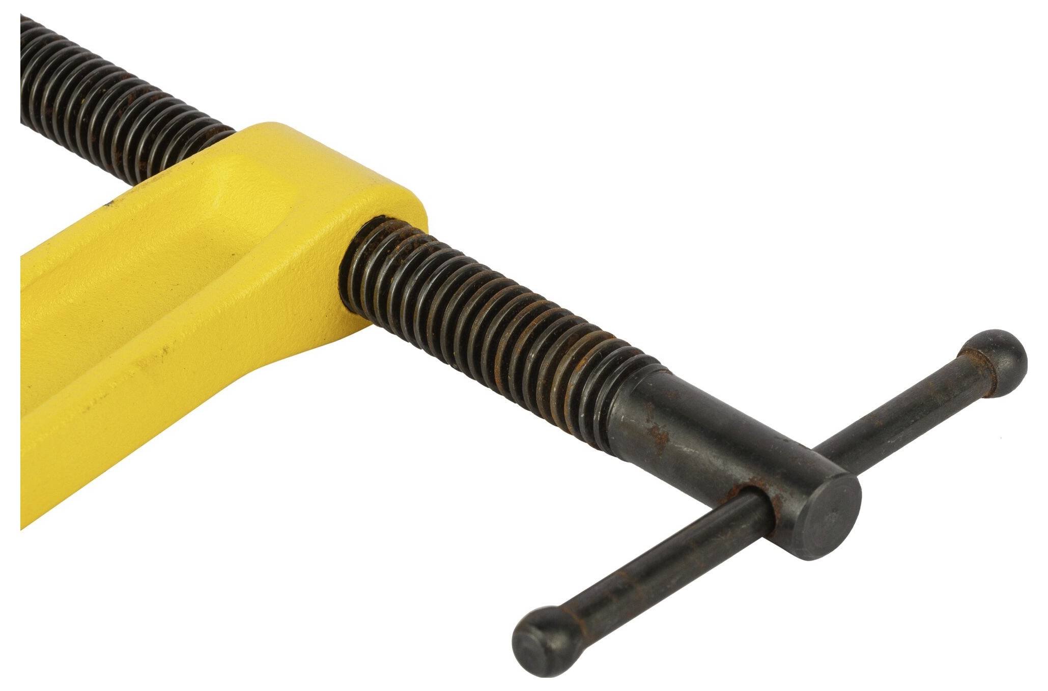 A yellow G-clamp with a black spindle and crossbar, ready to secure workpieces or materials.