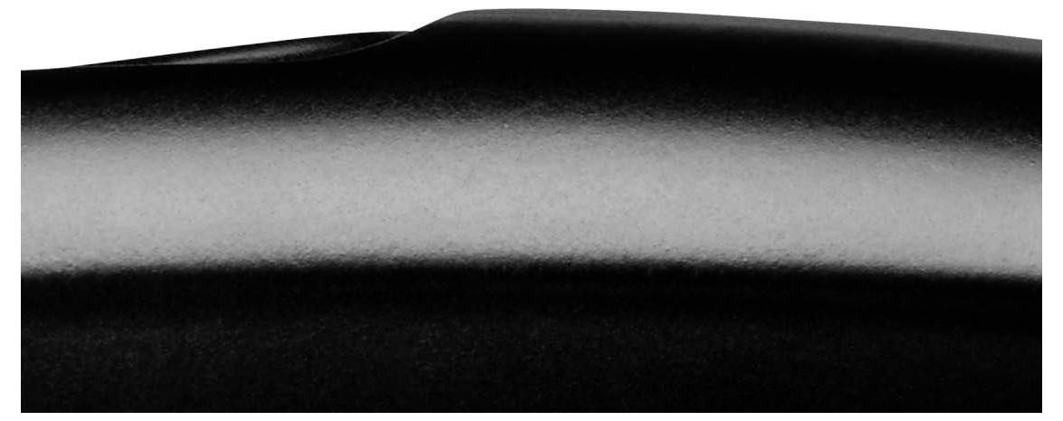 Black glossy surface with soft light reflection, revealing a gentle curvature.