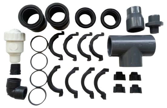 Various plastic pipe connectors and seals in different shapes and sizes, used for installing piping systems.