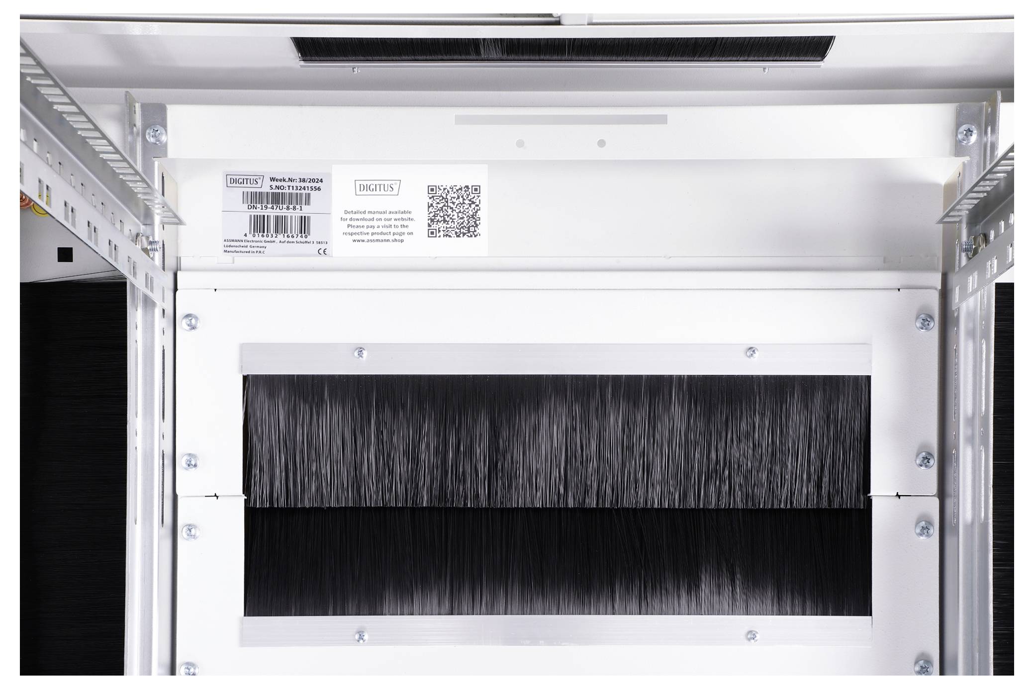 White metal structure with black brushes in the centre, surrounded by industrial frames. Labels and a QR code are located at the top.