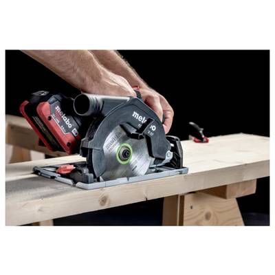 A person using a cordless circular saw to cut a wooden board on a workbench, focusing on precision and control.