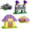 Building blocks in the shape of a small castle, a house, and a seated figure. Colours: Purple, Grey, Green, Yellow.