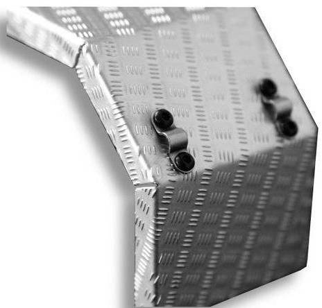 Close-up of a silver metallic structure with a corrugated surface and two visible screws connecting a corner.