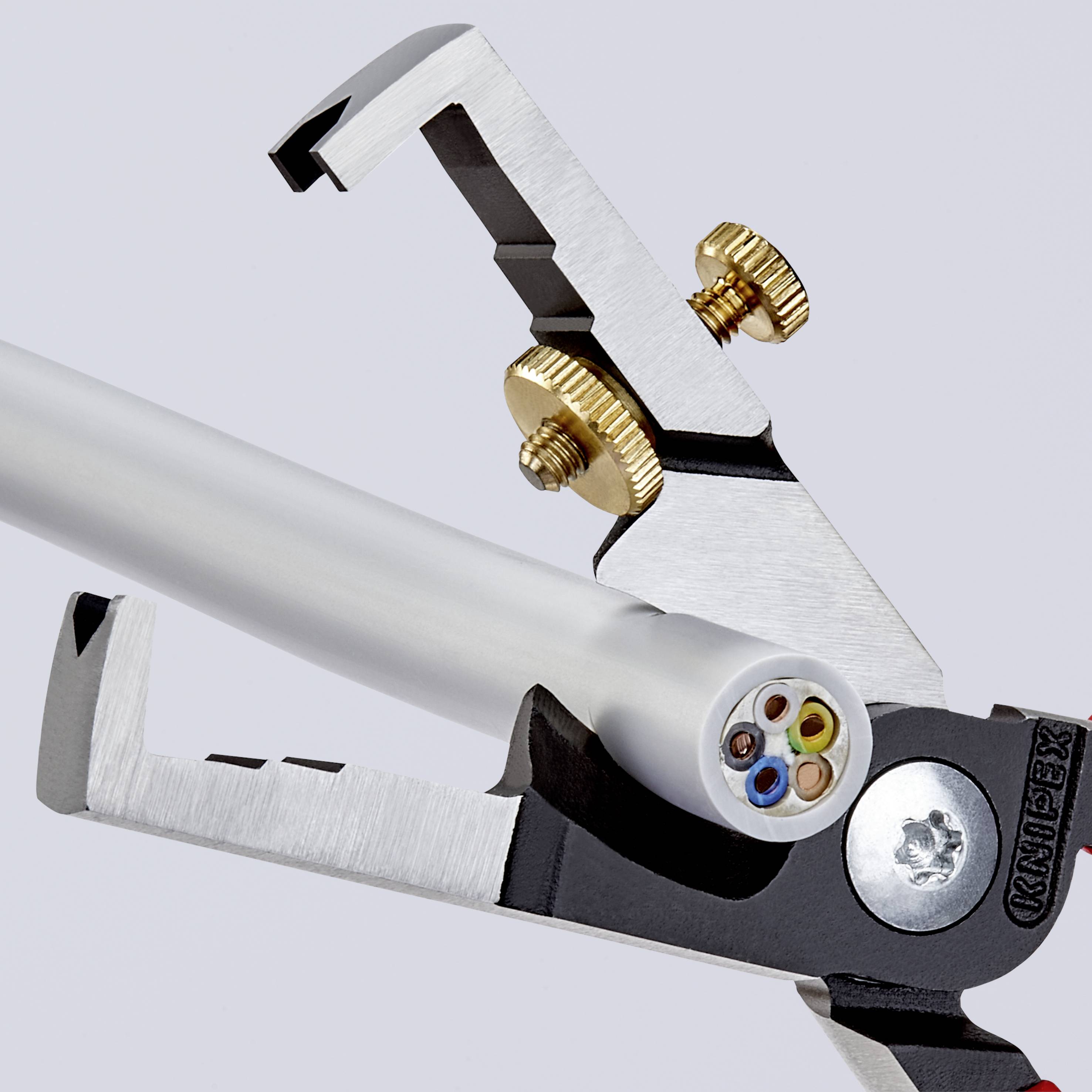 Wire strippers remove the plastic insulation from a metal cable, revealing the exposed wires.