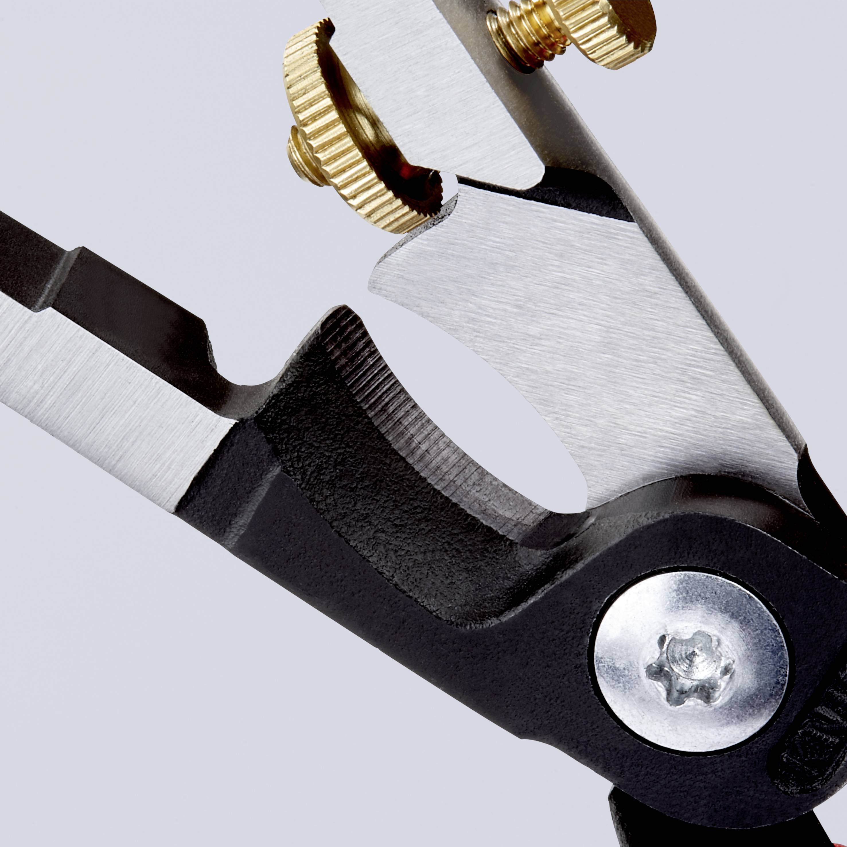 Close-up of a metal tool with a serrated blade and golden adjustment screws against a grey background.